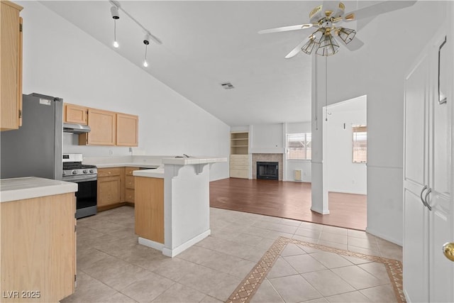 920 Serpentina Ave, Las Vegas, NV 89123 - kitchen with stainless steel range with gas cooktop, light brown cabinets, light tile patterned floors, ceiling fan, and open floor plan
