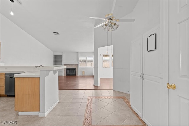 920 Serpentina Ave, Las Vegas, NV 89123 - kitchen with dishwasher, a ceiling fan, lofted ceiling, a fireplace, and light tile patterned floors