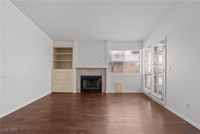 920 Serpentina Ave, Las Vegas, NV 89123 - unfurnished living room featuring wood finished floors, a fireplace, and built in shelves