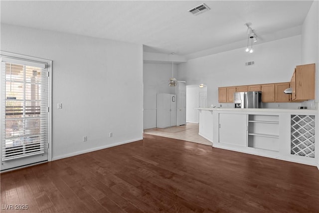 920 Serpentina Ave, Las Vegas, NV 89123 - unfurnished living room with a ceiling fan, wood finished floors, and rail lighting