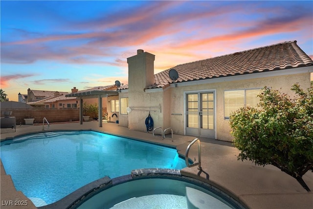 920 Serpentina Ave, Las Vegas, NV 89123 - pool at dusk with a pool with connected hot tub and a patio area