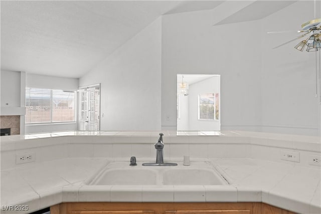 920 Serpentina Ave, Las Vegas, NV 89123 - kitchen with tile counters, healthy amount of natural light, lofted ceiling, ceiling fan, and a tile fireplace