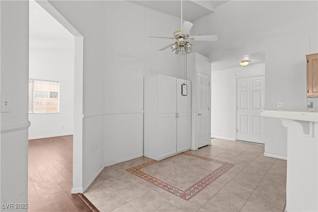 920 Serpentina Ave, Las Vegas, NV 89123 - kitchen featuring ceiling fan, light countertops, a breakfast bar area, and light tile patterned floors