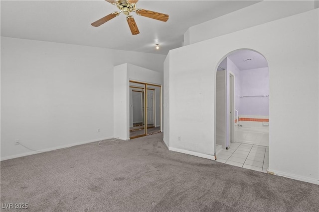 920 Serpentina Ave, Las Vegas, NV 89123 - carpeted empty room with arched walkways, ceiling fan, and tile patterned flooring