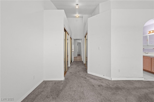 920 Serpentina Ave, Las Vegas, NV 89123 - corridor with light colored carpet and arched walkways