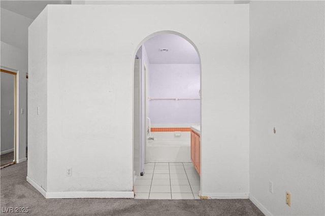 920 Serpentina Ave, Las Vegas, NV 89123 - spare room with arched walkways, light carpet, and light tile patterned floors