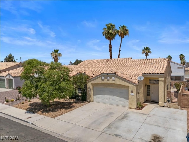 920 Serpentina Ave, Las Vegas, NV 89123 - view of front facade with a tiled roof, stucco siding, a garage, and concrete driveway