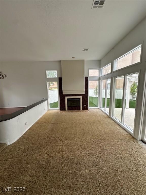 8761 Rainbow Ridge Dr, Las Vegas, NV 89117 - unfurnished living room with carpet and a fireplace with flush hearth