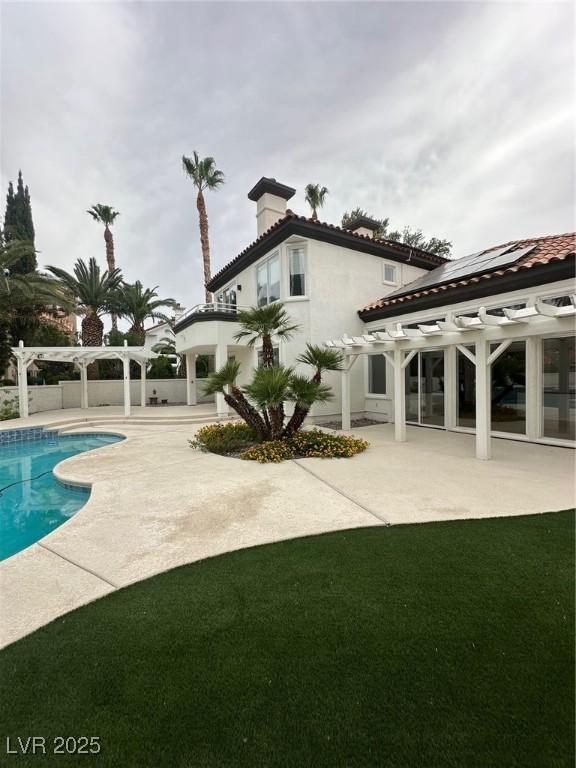8761 Rainbow Ridge Dr, Las Vegas, NV 89117 - back of house with a pergola, a patio, and a chimney