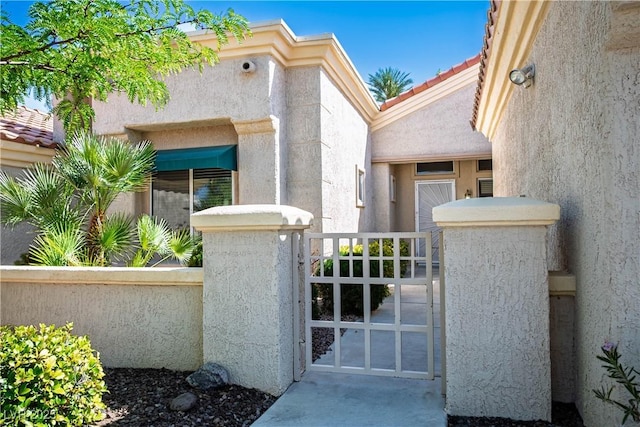 10305 Snyder Ave, Las Vegas, NV 89134 - entrance to property featuring stucco siding, a tiled roof, and a gate