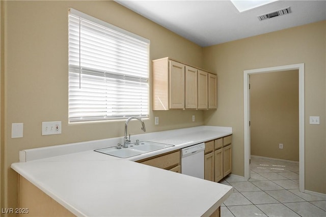 10305 Snyder Ave, Las Vegas, NV 89134 - kitchen with white dishwasher, light brown cabinetry, a peninsula, light countertops, and light tile patterned floors