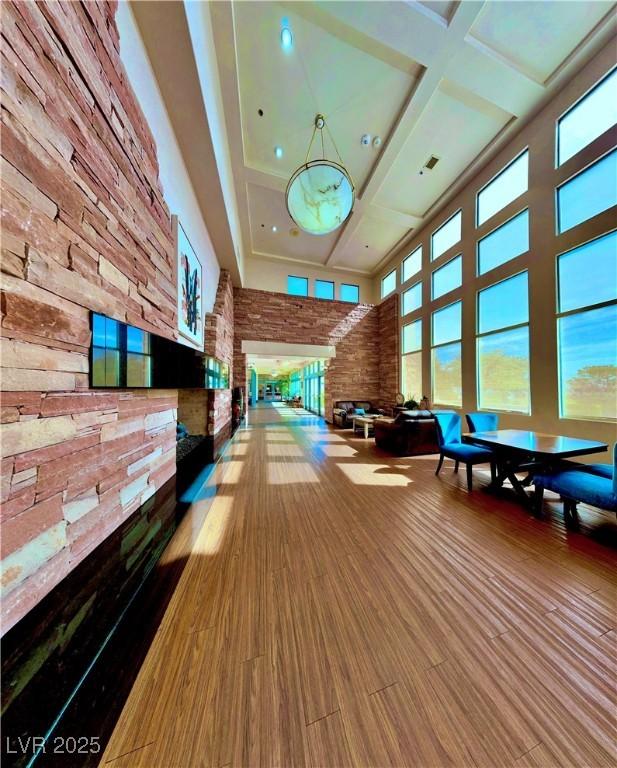 10305 Snyder Ave, Las Vegas, NV 89134 - rec room featuring a high ceiling, coffered ceiling, wood finished floors, and beam ceiling