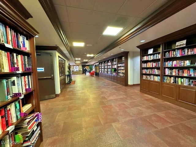 10305 Snyder Ave, Las Vegas, NV 89134 - misc room featuring wall of books, stone finish flooring, and a paneled ceiling