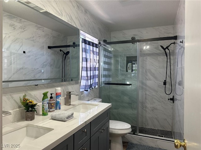 8901 Kingswood Dr, Las Vegas, NV 89147 - full bathroom featuring double vanity, a marble finish shower, and decorative backsplash