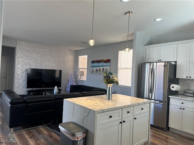 8901 Kingswood Dr, Las Vegas, NV 89147 - kitchen featuring freestanding refrigerator, dark wood-style floors, white cabinetry, pendant lighting, and a center island