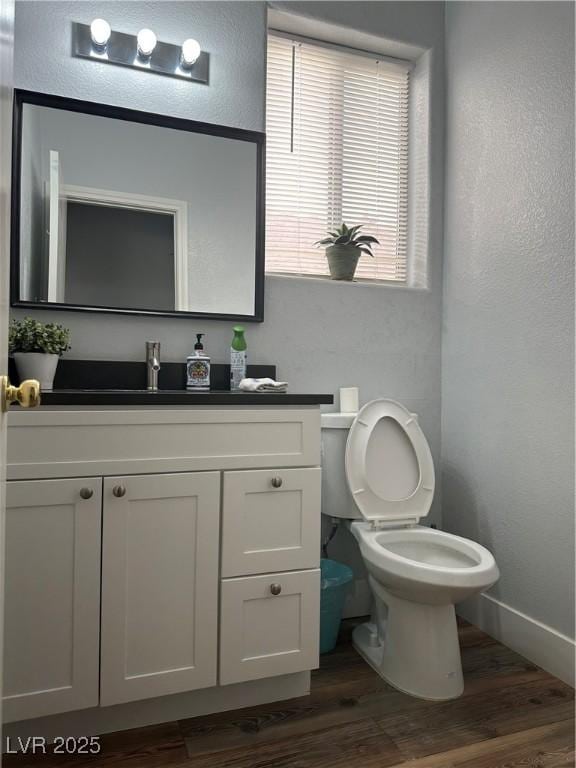 8901 Kingswood Dr, Las Vegas, NV 89147 - bathroom with vanity, wood finished floors, and a textured wall