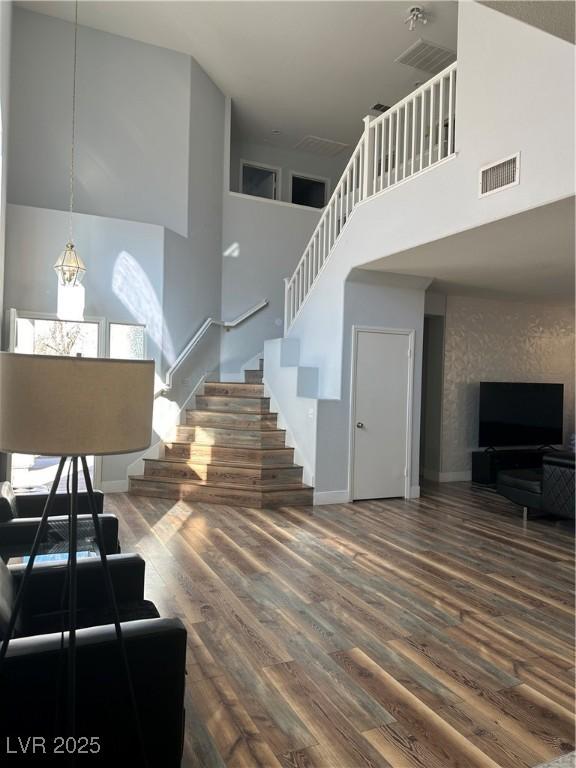 8901 Kingswood Dr, Las Vegas, NV 89147 - stairs with a high ceiling and wood finished floors