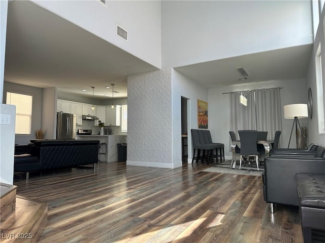 8901 Kingswood Dr, Las Vegas, NV 89147 - living area featuring dark wood-style flooring and a towering ceiling