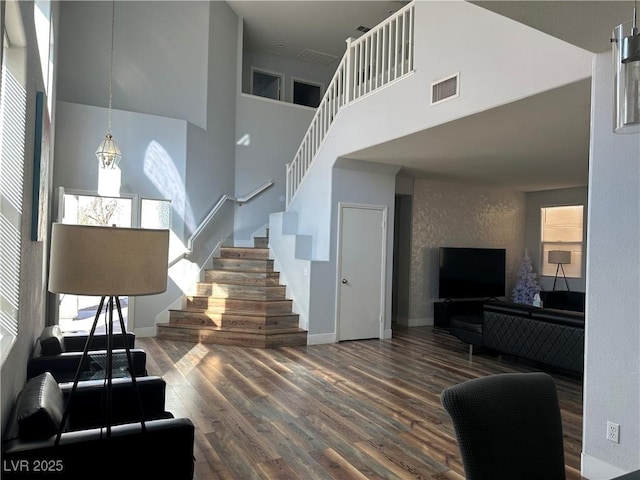 8901 Kingswood Dr, Las Vegas, NV 89147 - staircase featuring a towering ceiling and wood finished floors