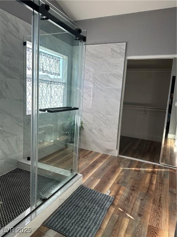 8901 Kingswood Dr, Las Vegas, NV 89147 - bathroom featuring a stall shower, wood finished floors, and a walk in closet
