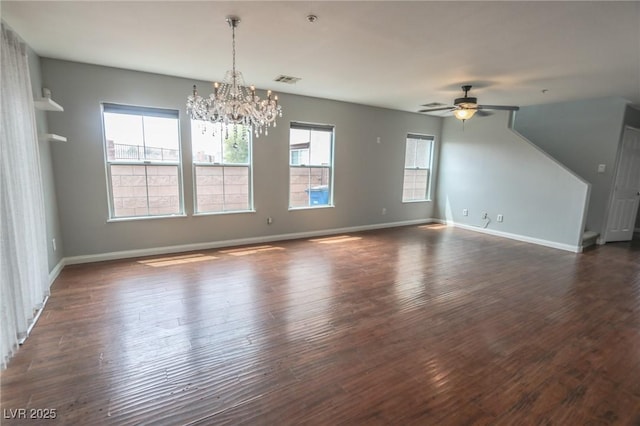 1135 Paradise Mountain Trl, Henderson, NV 89002 - unfurnished living room featuring a chandelier, ceiling fan, and dark wood finished floors