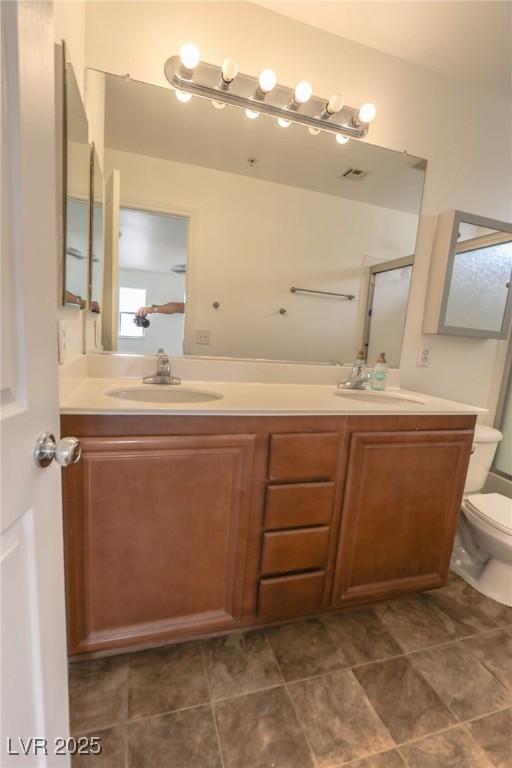 1135 Paradise Mountain Trl, Henderson, NV 89002 - full bathroom featuring double vanity, a shower with door, and tile patterned floors