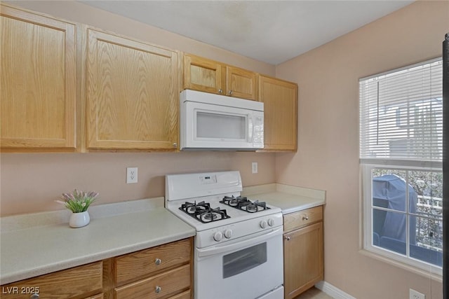6217 Lapilli Ave, Las Vegas, NV 89139 - kitchen featuring white appliances, light brown cabinetry, and light countertops