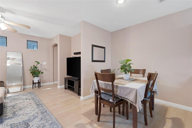 6217 Lapilli Ave, Las Vegas, NV 89139 - dining room with ceiling fan, arched walkways, and light wood-style floors