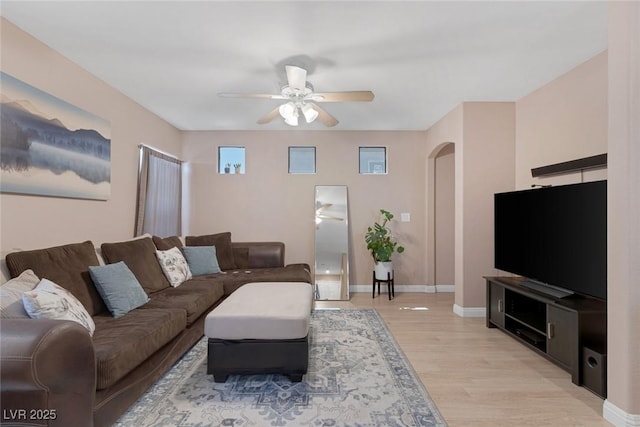 6217 Lapilli Ave, Las Vegas, NV 89139 - living area with ceiling fan, arched walkways, and light wood-style flooring