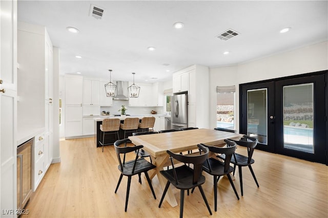 10645 Redwood Grove Ave, Las Vegas, NV 89144 - dining room with light wood-style flooring, recessed lighting, french doors, and wine cooler