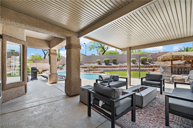 10645 Redwood Grove Ave, Las Vegas, NV 89144 - fenced backyard featuring an outdoor living space with a fire pit and a patio area