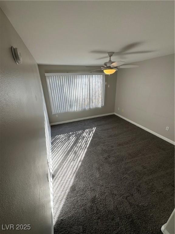 5710 E Tropicana Ave Unit 2225, Las Vegas, NV 89122 - empty room with ceiling fan and dark colored carpet