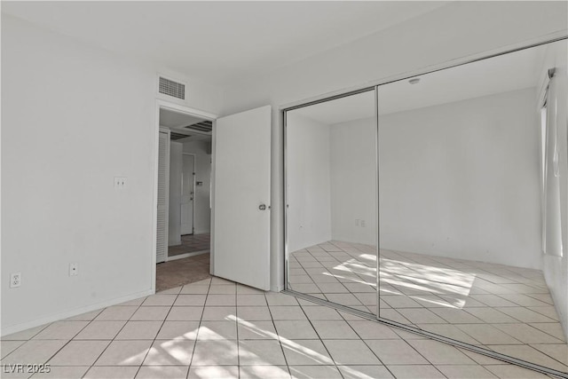 8070 W Russell Rd Unit 1023, Las Vegas, NV 89113 - unfurnished bedroom featuring a closet and light tile patterned floors