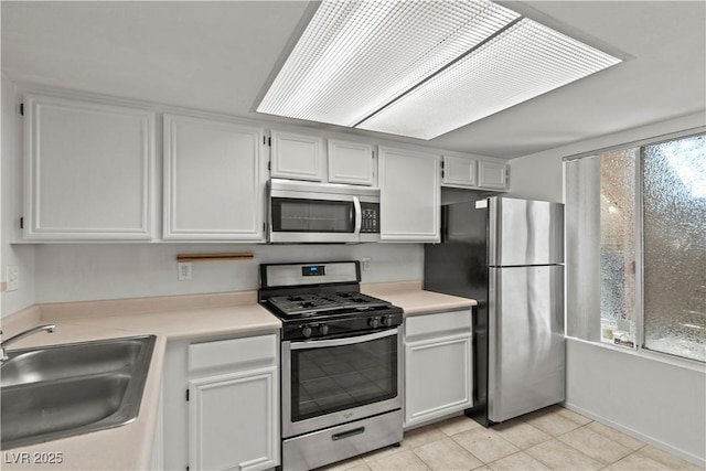 8070 W Russell Rd Unit 1023, Las Vegas, NV 89113 - kitchen featuring appliances with stainless steel finishes, light countertops, light tile patterned flooring, and white cabinets