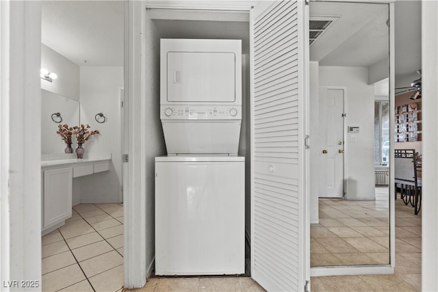 8070 W Russell Rd Unit 1023, Las Vegas, NV 89113 - washroom featuring stacked washer and clothes dryer and light tile patterned floors