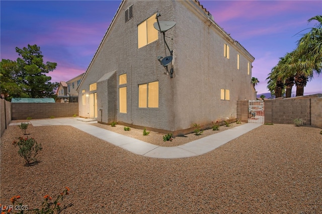 9011 Aldershot Ct, Las Vegas, NV 89147 - property exterior at dusk featuring a fenced backyard and stucco siding