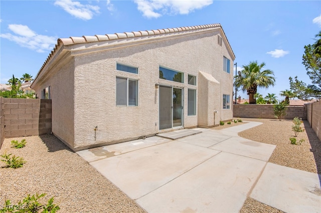 9011 Aldershot Ct, Las Vegas, NV 89147 - rear view of property with a fenced backyard, stucco siding, a patio, and a tiled roof