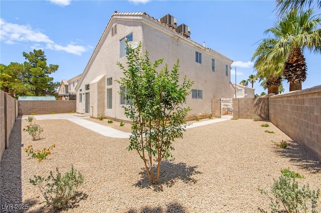 9011 Aldershot Ct, Las Vegas, NV 89147 - rear view of house with a fenced backyard, stucco siding, and a gate