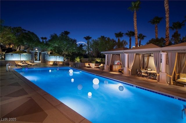 1 Hughes Center Dr Unit 903, Las Vegas, NV 89169 - pool at night with a gazebo, a community pool, and a patio