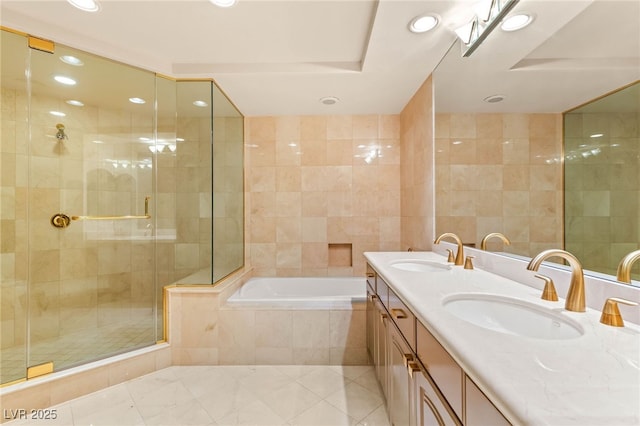 1 Hughes Center Dr Unit 903, Las Vegas, NV 89169 - bathroom featuring recessed lighting, double vanity, a garden tub, a stall shower, and tile walls