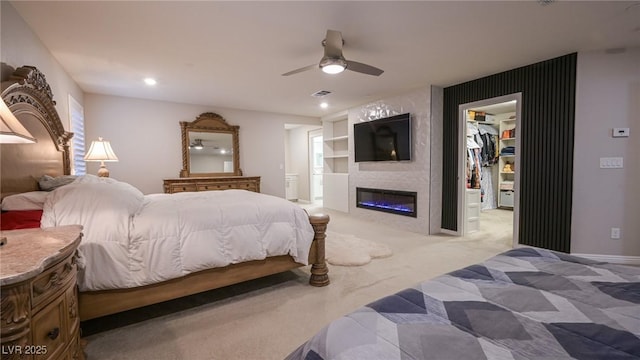 2913 Monate Ct, Henderson, NV 89044 - carpeted bedroom with a spacious closet, a fireplace, a ceiling fan, and a closet