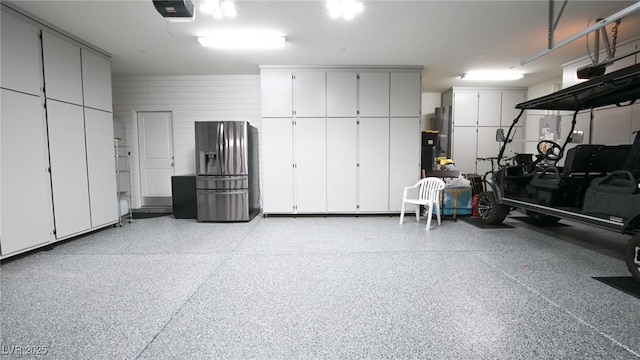 2913 Monate Ct, Henderson, NV 89044 - garage with stainless steel refrigerator with ice dispenser, a garage door opener, and fridge