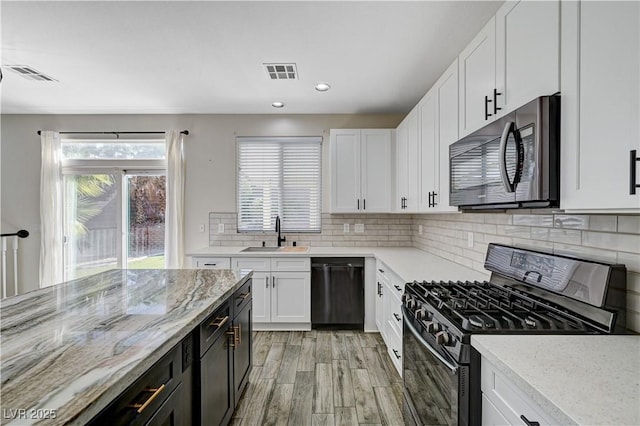 9021 Rendon St, Las Vegas, NV 89143 - kitchen featuring gas stove, stainless steel microwave, dishwasher, white cabinetry, and recessed lighting