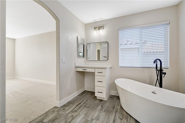 9021 Rendon St, Las Vegas, NV 89143 - bathroom with wood finished floors, a soaking tub, and vanity