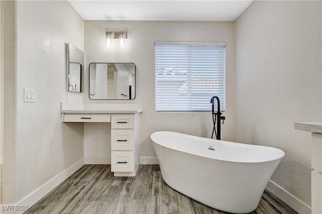9021 Rendon St, Las Vegas, NV 89143 - bathroom with vanity, a freestanding bath, and wood finished floors