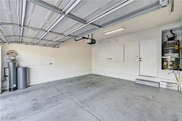 9021 Rendon St, Las Vegas, NV 89143 - garage featuring strapped water heater and a garage door opener