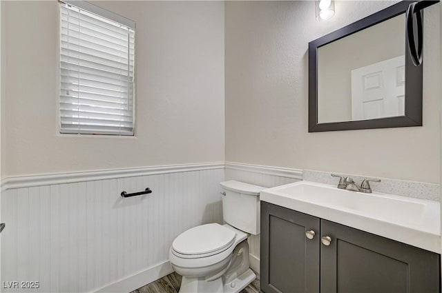 9021 Rendon St, Las Vegas, NV 89143 - half bath with a wainscoted wall, vanity, and wood finished floors