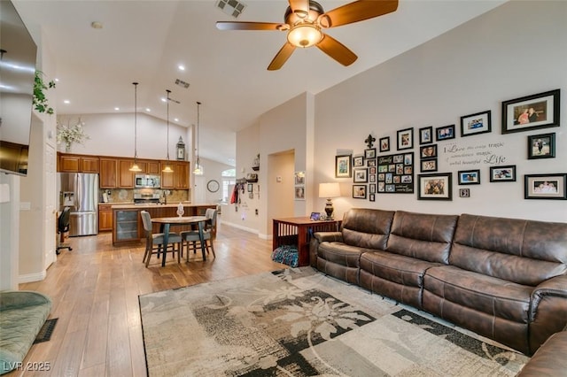 1779 Antelope Valley Ave, Henderson, NV 89012 - living room with high vaulted ceiling, ceiling fan, light wood-style flooring, and recessed lighting