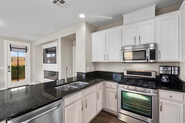 8353 Lower Trailhead Ave, Las Vegas, NV 89113 - kitchen with stainless steel appliances, dark stone countertops, white cabinetry, and recessed lighting