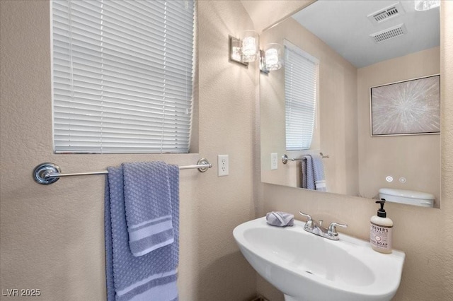 8353 Lower Trailhead Ave, Las Vegas, NV 89113 - bathroom featuring a sink and a textured wall